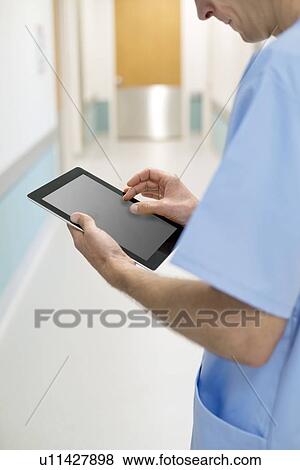 Surgeon using digital tablet, close up. View Large Photo Image Stock Photo - Surgeon using digital tablet, close up.. Fotosearch