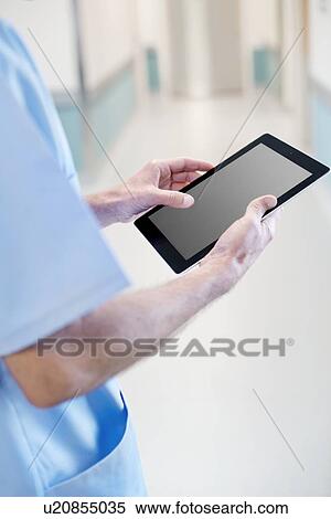 Surgeon using digital tablet, close up. View Large Photo Image Stock Photography - Surgeon using digital tablet, close up.. Fotosearch