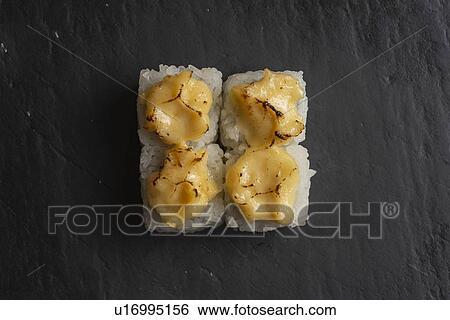Stock Photograph - Sushi with burnt yellow sauce. Fotosearch