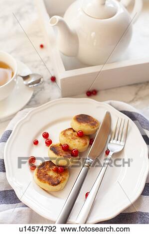 Stock Image - Syrniki with cranberries. Fotosearch