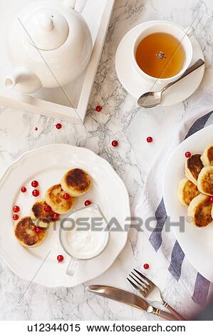 Stock Photography - Syrniki with cranberries. Fotosearch