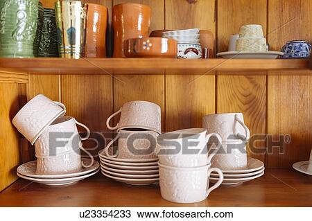 Stock Image - Tableware on wooden shelves. Fotosearch