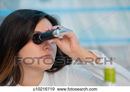 Technician in quality control laboratory using a refractometer. View Large Photo Image Stock Photo - Technician in quality control laboratory using a refractometer.. Fotosearch