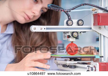 Stock Photo - Technician using 3D printer.. Fotosearch