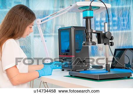 Stock Photo - Technician using 3D printer.. Fotosearch