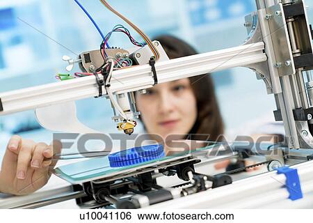 Stock Photograph - Technician working on 3D printer.. Fotosearch