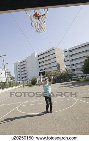 Teenage ball shooting basketball View Large Photo Image Stock Image - Teenage ball shooting basketball. Fotosearch