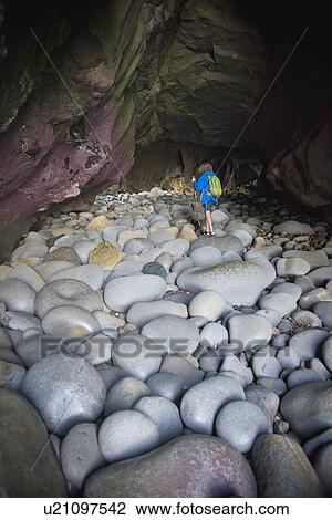 Teenage boy exploring cave with rocks in La Jolla, California View Large Photo Image Stock Image - Teenage boy exploring cave with rocks in La Jolla, California. Fotosearch