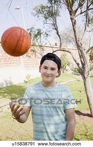 Teenage boy throwing basketball View Large Photo Image Stock Image - Teenage boy throwing basketball. Fotosearch