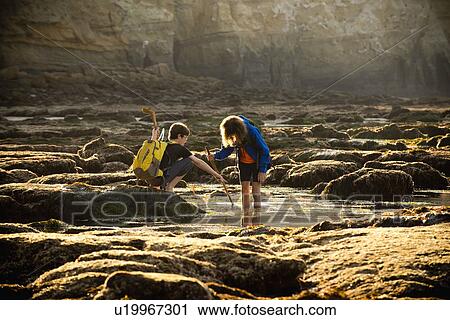 Teenage boys on rocks by tide pool in La Jolla, California View Large Photo Image Stock Image - Teenage boys on rocks by tide pool in La Jolla, California. Fotosearch