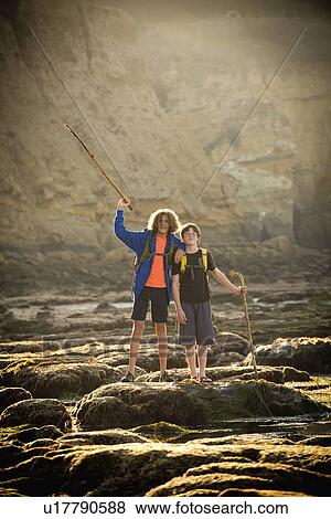 Stock Photo - Teenage boys on rocks by tide pool in La Jolla, California. Fotosearch