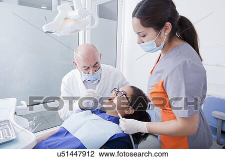 Teenage girl getting dental cleaning View Large Photo Image Stock Image - Teenage girl getting dental cleaning. Fotosearch