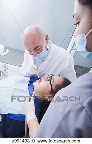 Teenage girl getting dental cleaning View Large Photo Image Stock Image - Teenage girl getting dental cleaning. Fotosearch