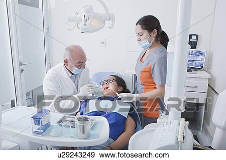 Stock Photo - Teenage girl getting dental cleaning. Fotosearch