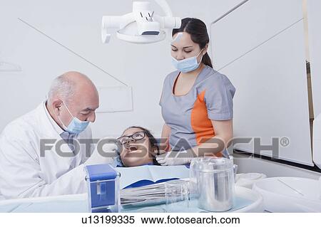 Stock Photography - Teenage girl getting dental cleaning. Fotosearch