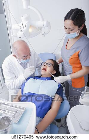 Stock Photography - Teenage girl getting dental cleaning. Fotosearch
