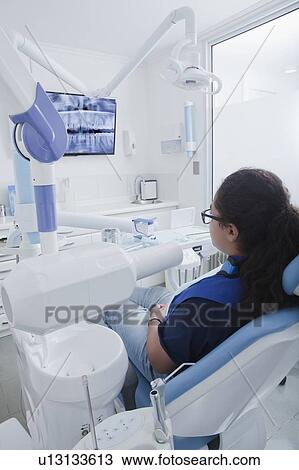 Teenage girl in dentist's chair View Large Photo Image Stock Image - Teenage girl in dentist's chair. Fotosearch