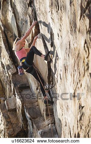 Picture - Teenage girl rock climbing. Fotosearch