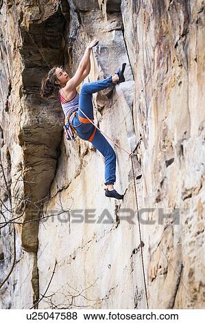 Stock Photo - Teenage girl rock climbing. Fotosearch