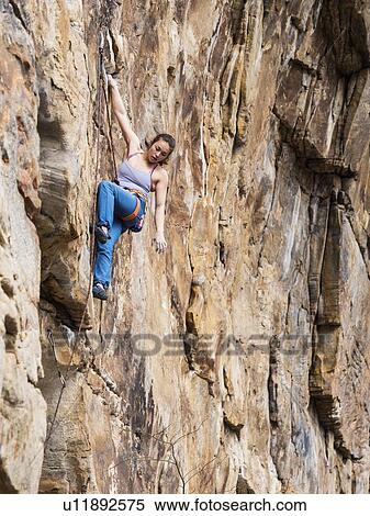 Stock Photography - Teenage girl rock climbing. Fotosearch