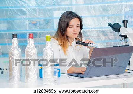 Stock Photography - Testing wine in quality control lab.. Fotosearch