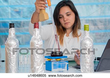 Stock Photography - Testing wine in quality control lab.. Fotosearch