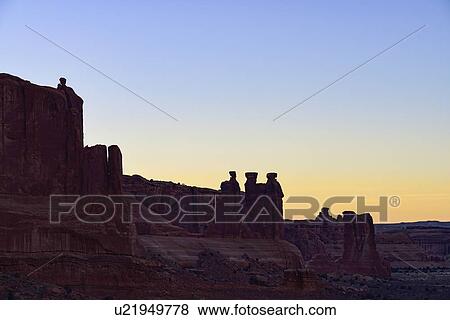 Stock Photo - The Three Gossips at sunset in Arches National Park, Utah, USA. Fotosearch