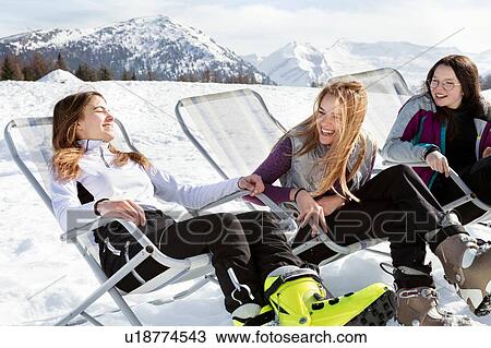 Three teenage girl skiers sitting in deck chairs in snow covered landscape, Tyrol, Styria, Austria View Large Photo Image Stock Image - Three teenage girl skiers sitting in deck chairs in snow covered landscape, Tyrol, Styria, Austria. Fotosearch