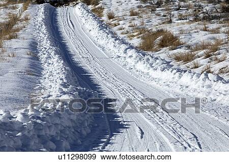 Tire tracks through snow View Large Photo Image Stock Photo - Tire tracks through snow. Fotosearch