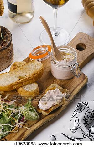 Toast and jar of spread on cutting board View Large Photo Image Stock Photo - Toast and jar of spread on cutting board. Fotosearch