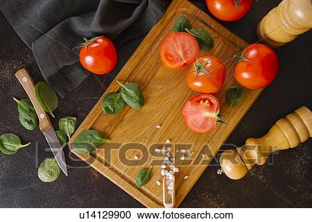 Tomatoes, basil and salt on wooden cutting board View Large Photo Image Stock Image - Tomatoes, basil and salt on wooden cutting board. Fotosearch