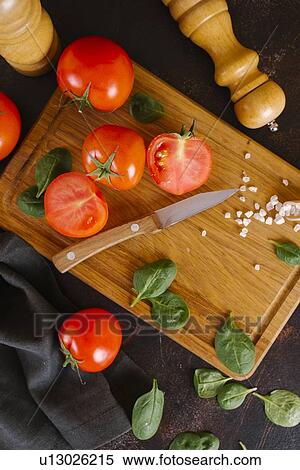 Tomatoes, basil and salt on wooden cutting board View Large Photo Image Stock Photography - Tomatoes, basil and salt on wooden cutting board. Fotosearch