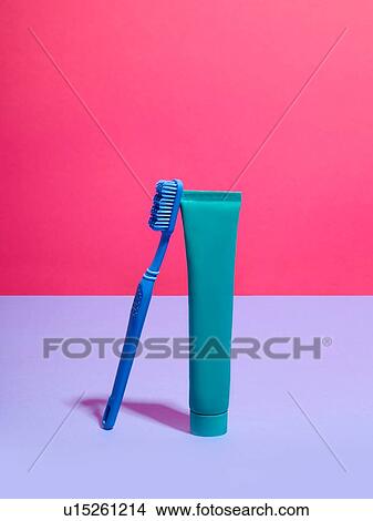 Toothbrush and toothpaste against pink and lilac background View Large Photo Image Picture - Toothbrush and toothpaste against pink and lilac background. Fotosearch