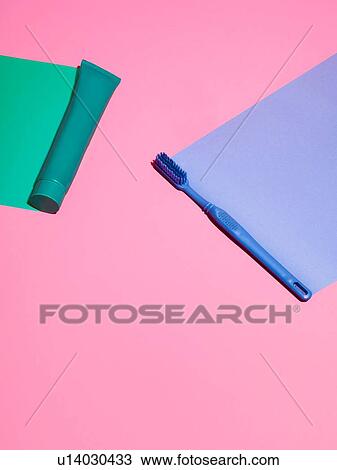 Stock Image - Toothbrush and toothpaste on pink background. Fotosearch