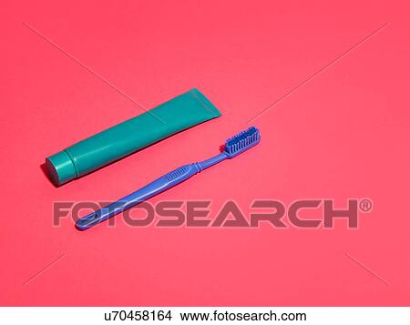 Toothbrush and toothpaste on red background View Large Photo Image Picture - Toothbrush and toothpaste on red background. Fotosearch