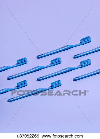 Toothbrushes arranged in rows on lilac background View Large Photo Image Stock Photography - Toothbrushes arranged in rows on lilac background. Fotosearch