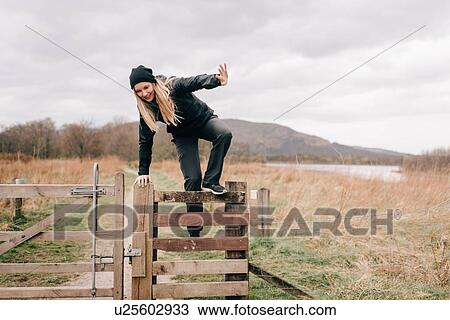 Trekker climbing over fence by Loch Lomond, Trossachs National Park, Canada View Large Photo Image Stock Image - Trekker climbing over fence by Loch Lomond, Trossachs National Park, Canada. Fotosearch