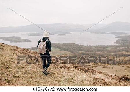 Stock Image - Trekker enjoying view of Loch Lomond, Trossachs National Park, Canada. Fotosearch