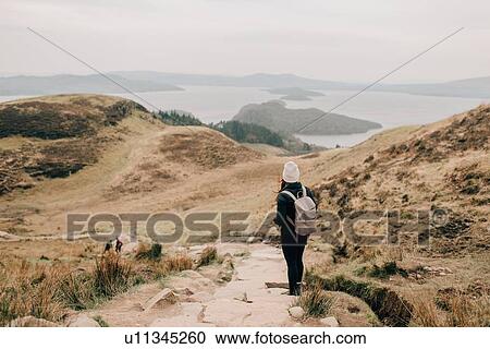 Stock Image - Trekker enjoying view of Loch Lomond, Trossachs National Park, Canada. Fotosearch