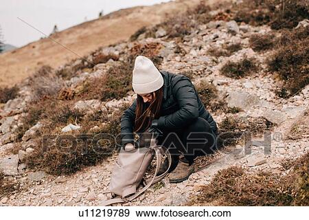 Trekker searching in bag, Trossachs National Park, Canada View Large Photo Image Stock Photo - Trekker searching in bag, Trossachs National Park, Canada. Fotosearch