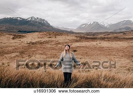Stock Photograph - Trekker taking in fresh air, Trossachs National Park, Canada. Fotosearch