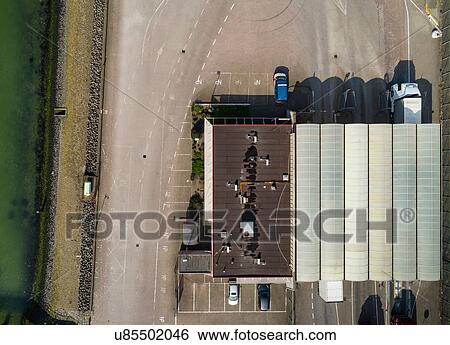 Stock Photograph - Trucks passing customs office before ferry journey to UK, overhead view, Hook of Holland, Zuid-Holland, Netherlands. Fotosearch