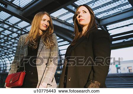 Two young women on stairway in train station, Turin, Piemonte, Italy View Large Photo Image Stock Image - Two young women on stairway in train station, Turin, Piemonte, Italy. Fotosearch