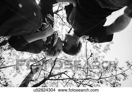 Upside down view of young couple face to face View Large Photo Image Picture - Upside down view of young couple face to face. Fotosearch
