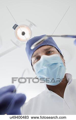 View directly below dentist during examination View Large Photo Image Stock Image - View directly below dentist during examination. Fotosearch