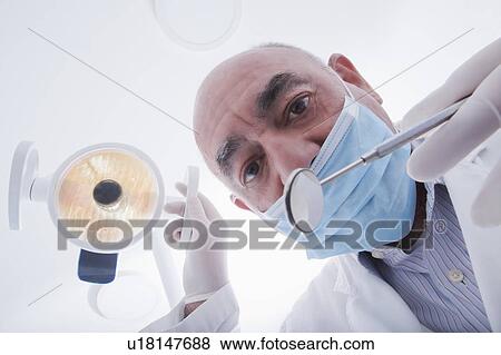 Stock Photo - View directly below dentist during examination. Fotosearch