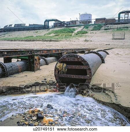 Stock Image - Wastewater being discharged into the sea from chemical works, UK.. Fotosearch