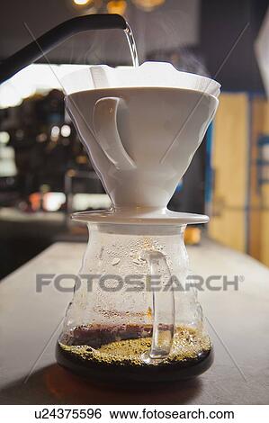 Water being poured into filter coffee View Large Photo Image Stock Photograph - Water being poured into filter coffee. Fotosearch