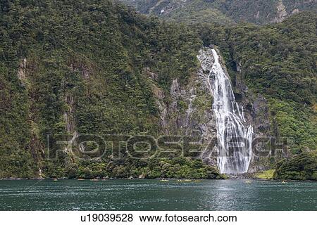 Stock Photo - Waterfall in Milford Sound, New Zealand. Fotosearch