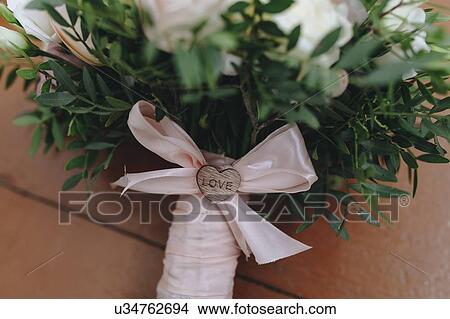 Wedding bouquet tied with pink ribbon View Large Photo Image Picture - Wedding bouquet tied with pink ribbon. Fotosearch